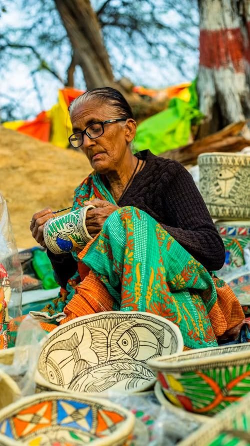 Artisan hand-painting traditional crafts at the Aadhi Shakthi exhibition in Coimbatore